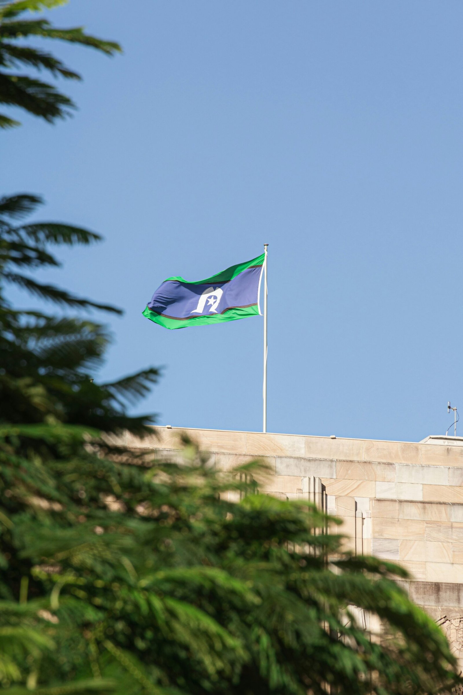 a flag flying on top of a building